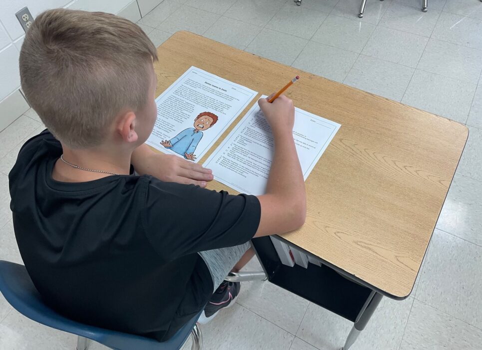 image shows student taking reading comprehension pre-assessment