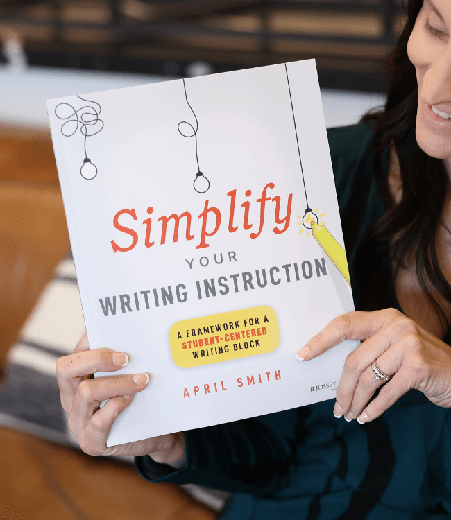 April holding the book Simplify Your Writing Instruction
